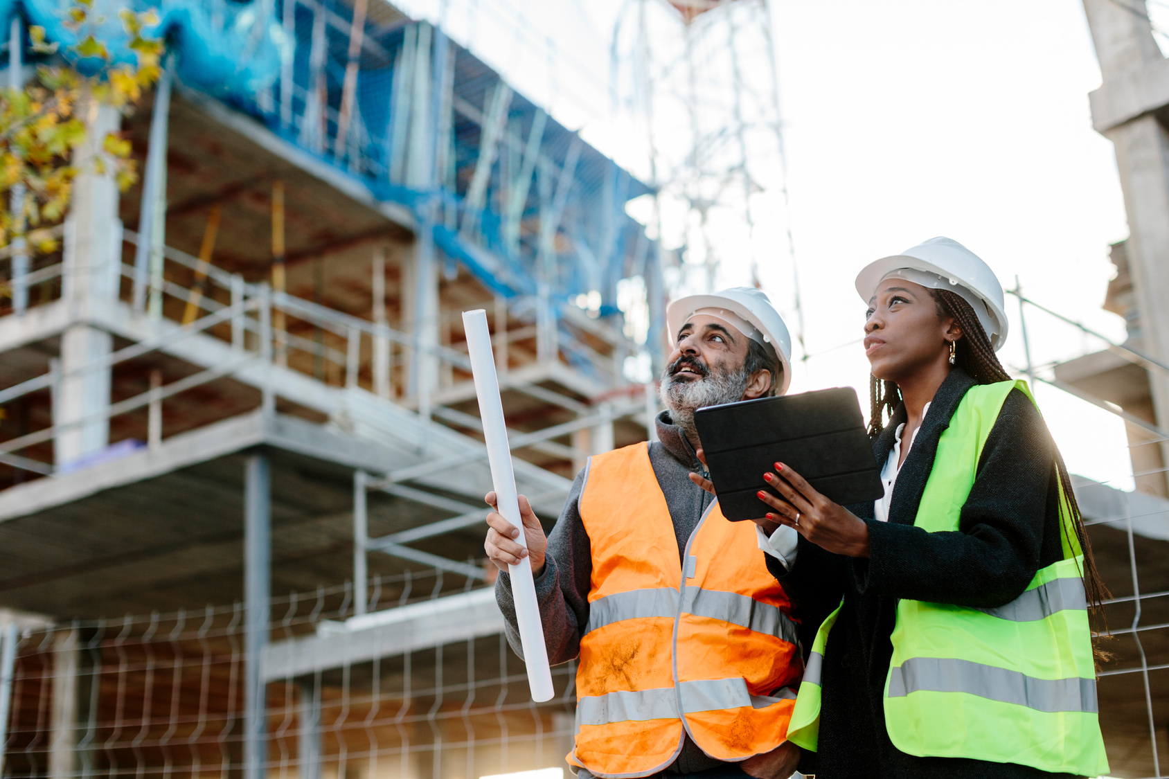 Construction team reviewing plans and reports on site